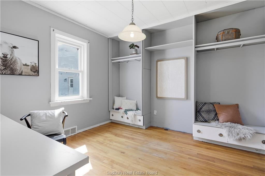 Second main-floor room — bedroom, office or den